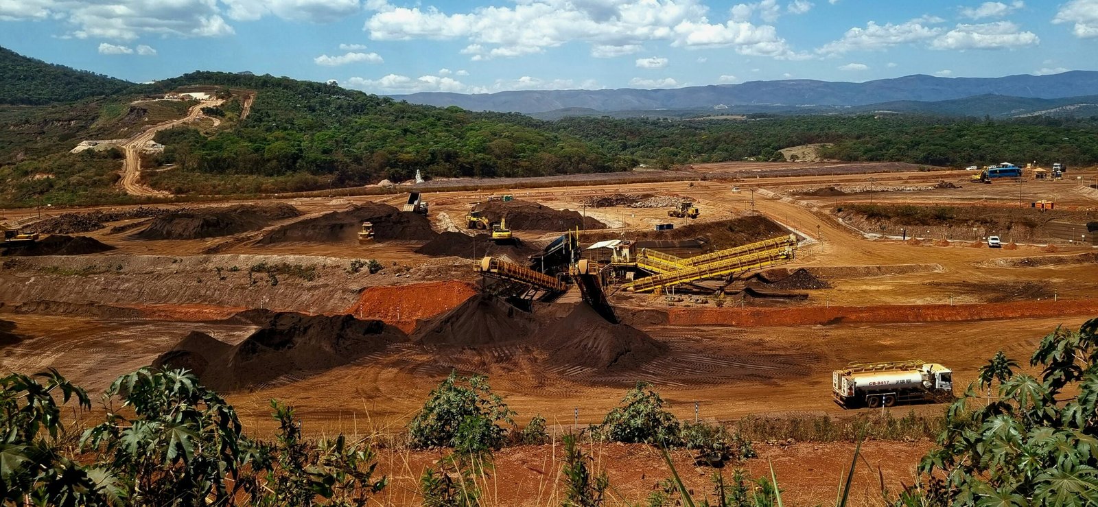 a construction site with a large amount of dirt in the foreground